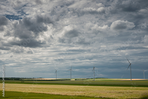 A view of large wind turbines in a field photo