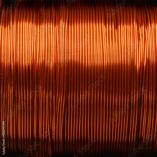 Copper wire, enamelled, on a coil, close up. Double coated and insulated copper winding wire on a spool, for electric motors, transformers and electronic projects, with a thickness of 0.30 mm. Photo.