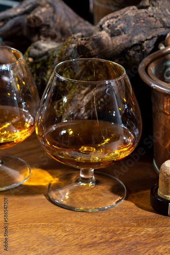 Tasting of aged french cognac brandy alcoholic drink in old cellars of cognac-producing regions Champagne or Bois, France