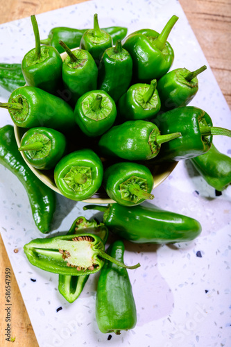 Fresh green mild padron pepper pementos, ready for grill or to be fried with olive oil, traditional snack in Galicia, Spain photo