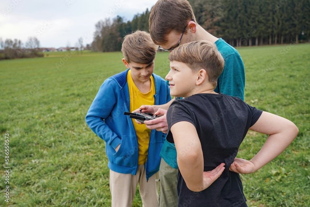 Children together launch the quadcopter and control it from the remote control. Children together launch the quadcopter and control it from the remote control.