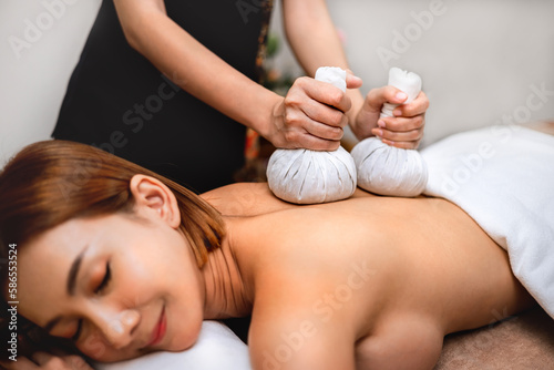 Beautiful woman doing Thai massage in spa