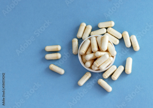 white pills bottle with vitamin c capsules with stethoscope and measure tape.loss weight slim fit concept healthy nutrition food supplements