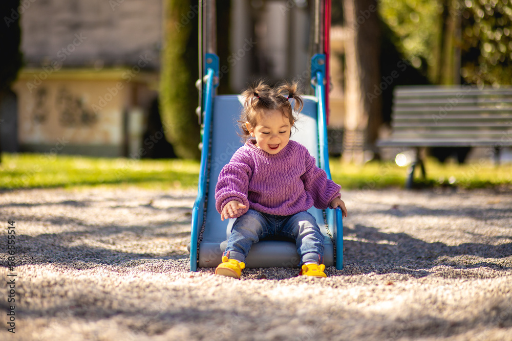Φωτογραφία Sweet caucasian little toddler girl with two tails having fun smiling widely sli