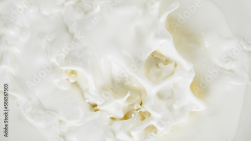 Freeze motion of whirling milk cream, close-up