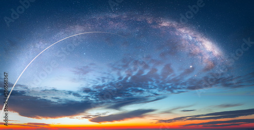 Fototapeta Naklejka Na Ścianę i Meble -  Long Exposure Night Time Rocket Launch - Planet Earth with a spectacular sunset Milky Way galaxy in the background 