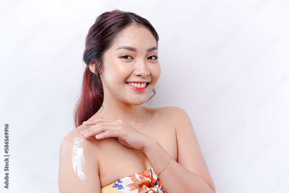 Skin Care Products Concept. Asian woman applying moisturizing lotion on body after shower