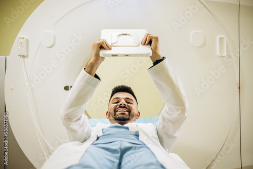 Man doctor with medical report by the MRI scanner