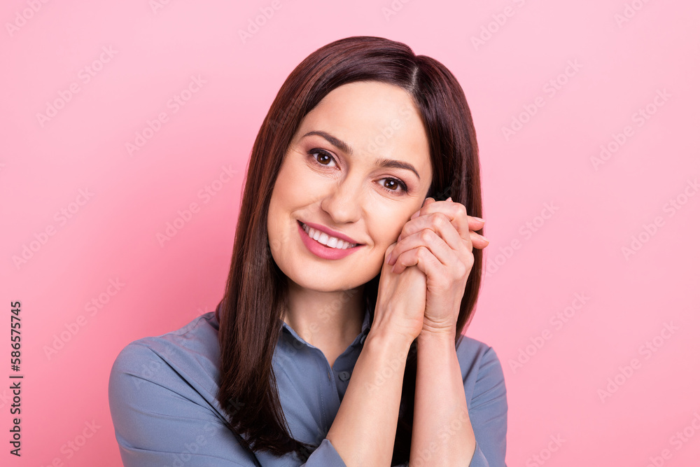 Closeup photo portrait of cute lovely girlish gorgeous lady hands together touch cheeks dreaming satisfied person isolated on pink color background Closeup photo portrait of cute lovely girlish gorgeous lady hands together touch cheeks dreaming satisfied person isolated on pink color background