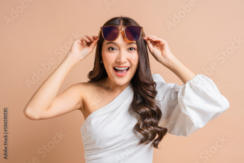 cheerful attractive glamour woman in white beautiful dress hand open sunglasses to look carefully to you for greeting surprise,woman in white dress happiness smiling laugh hand touch sun glasses