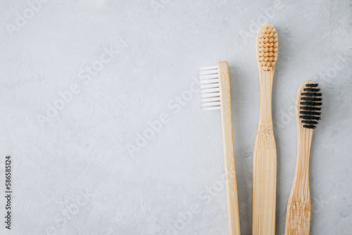 Bamboo toothbrushes. Eco friendly bamboo toothbrushes on gray stone background  top view with copy space.