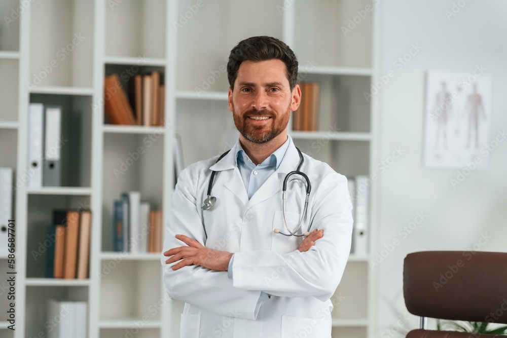 Standing in the office. Doctor in formal clothes is working in the cabinet Standing in the office. Doctor in formal clothes is working in the cabinet