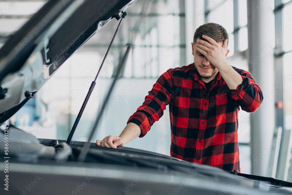 Young man making diagnostics of the vehicle