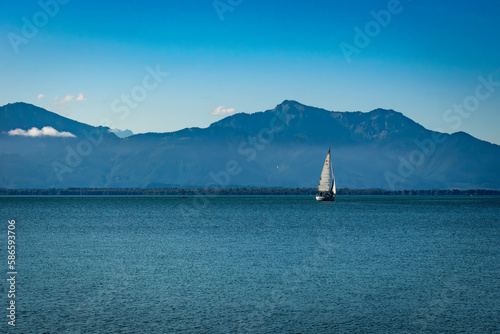 beautiful view of the lake chiemsee with the alps in background and sail boats