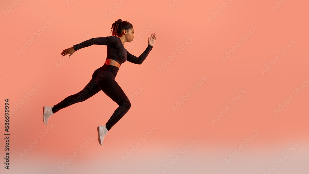 African american professional female athlete, runner training isolated on neon colored background, panorama, copy space