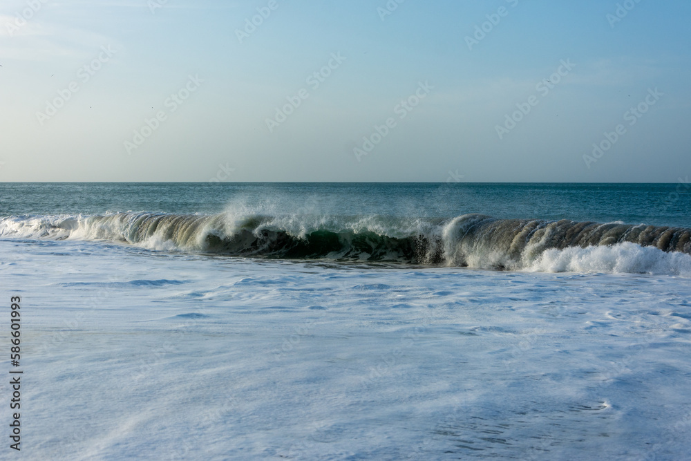 Sea reaching the shore. Waves crashing on the shore. Beach