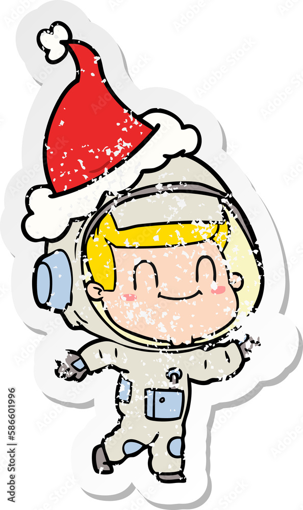 happy distressed sticker cartoon of a astronaut man wearing santa hat