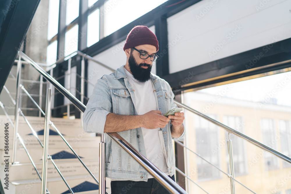 Focused man using smartphone on staircase Focused man using smartphone on staircase