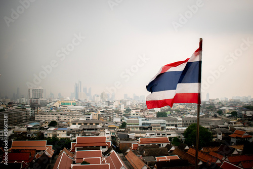 Thailand flag flying over a hazy Bangkok © Carl