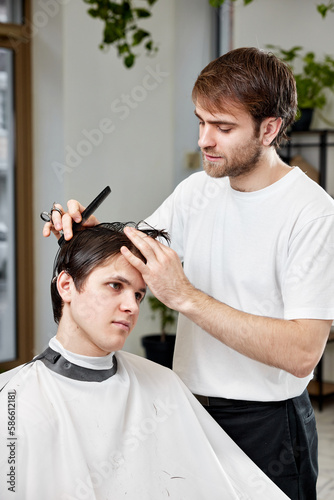 handsome young caucasian man visiting professional hairstylist