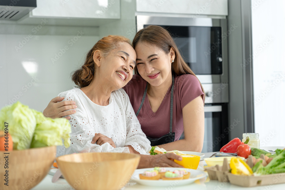 activities together during the holidays. mother and daughter are having a meal together during the holidays. asian female prepare breakfast on morning, enjoy, weekend, vacant, family time, happy.