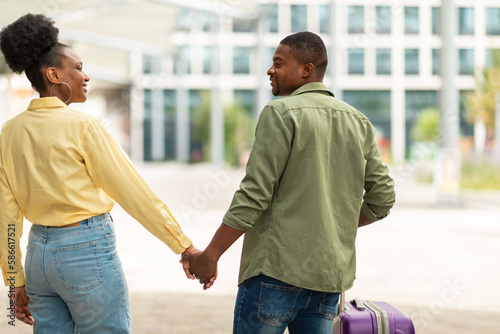 African American Spouses Traveling Standing With Suitcase Outdoor, Rear View © Prostock-studio