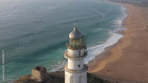 Aerial top view of trafalgar lighthouse in the Atlantic coast of Spain, next to Zahora and Caños de Meca towns photo