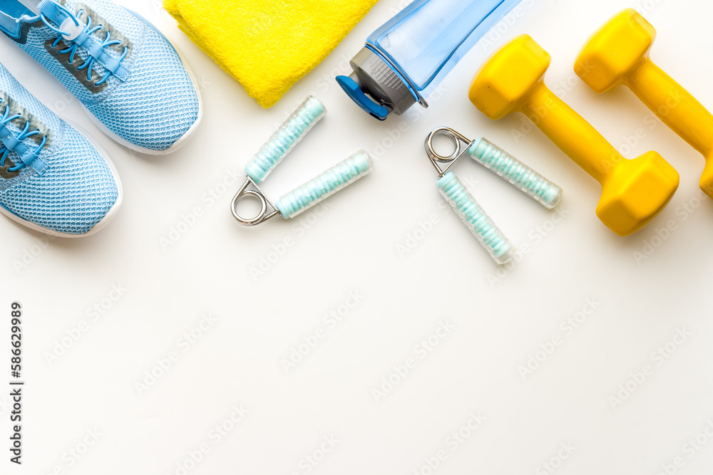 Fototapeta premium Gym and fitness equipment and workout tools with sneakers and dumbbells