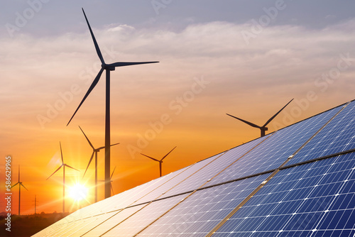 wind turbine with solar panels and sunset. concept clean energy. Energy supply, wind turbine,eolic turbine, distribution of energy,Powerplant,energy transmission,high voltage supply concept photo
