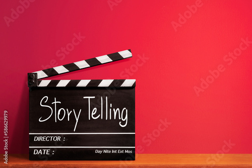 Storytelling, handwritten text title on film slate or movie clapper board and vision sharing concept in film industry. photo