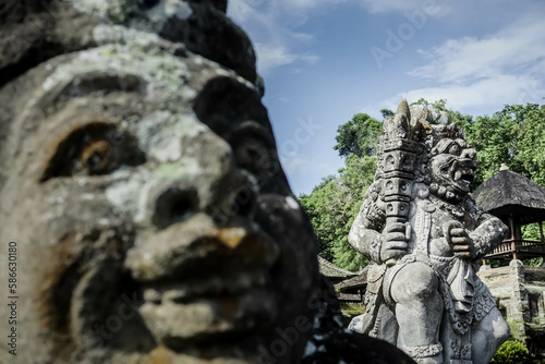 Traditional Balinese statues made of stone carvings in the form of gods, people or demons. Balinese sculpture in temple. © Rizky