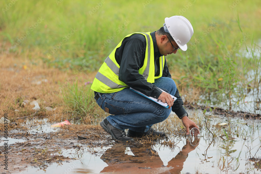 Environmental engineers work at water source to check for contaminants  in water sources and analysing water test results for reuse.World environment day concept.