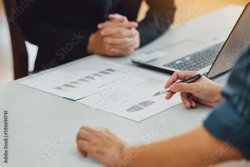 Two businessman investment consultant analyzing company financial report balance sheet statement working with documents graphs. Concept for stock market, office, tax, and project.
