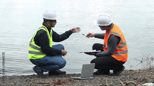 Wallpaper Mural Environmental two engineers work at water source to check for contaminants in water sources and analyzing water test results for reuse.World environment day concept. Torontodigital.ca