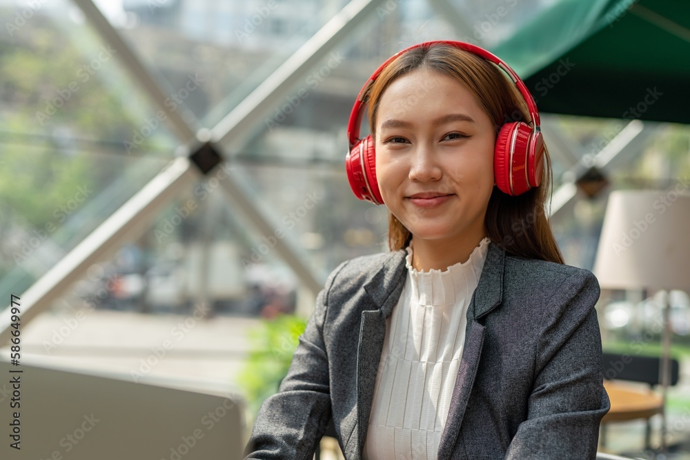Young asian businesswoman working on her computer laptop and wearing a ...
