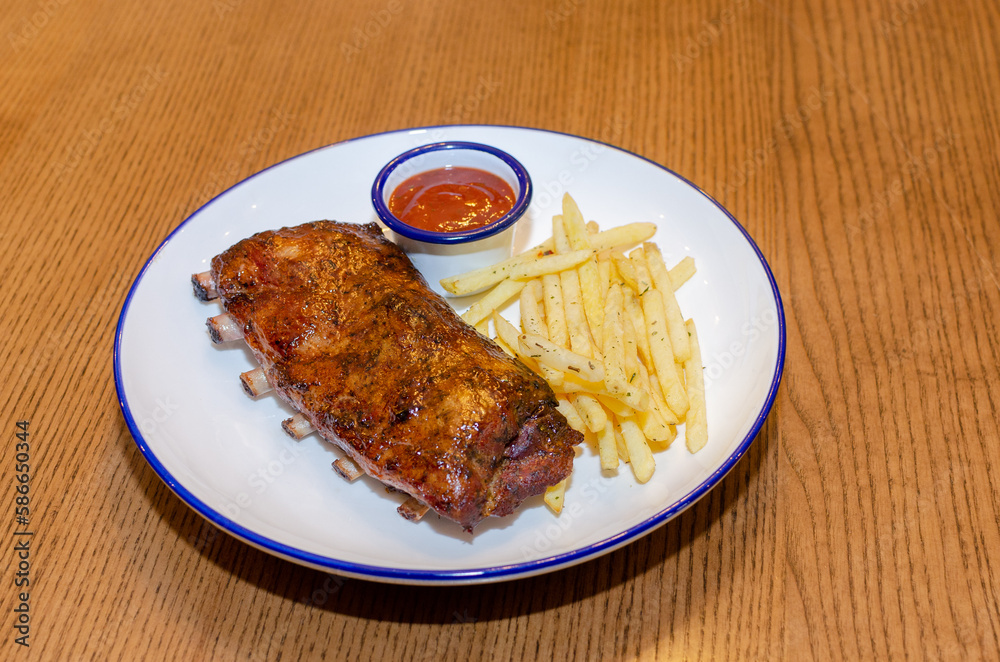 BBQ ribs with french fries and ketchup