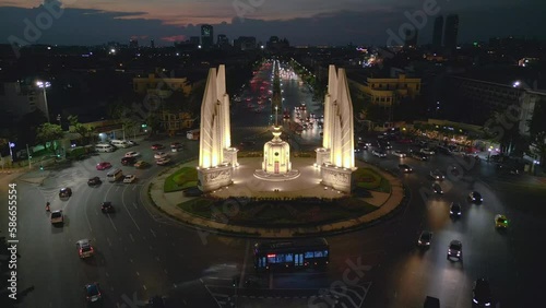 Cars drive turn in traffic circle bangkok. Smooth aerial view flight drone photo