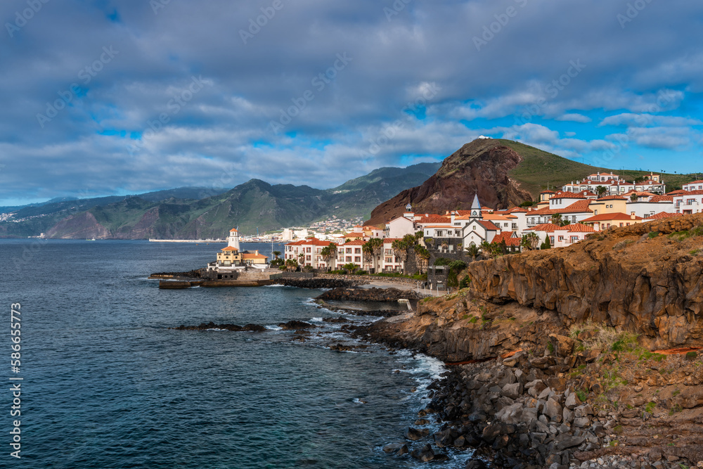 Fototapeta premium Marina da Quinta Grande, Madeira, Portugal. Seaside small village with lighthouse on rocky cliffs.
