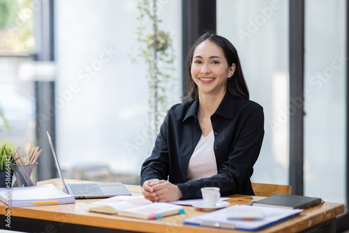 Portrait of business asian woman working on laptop in her workplace. asian smile business lady employee working on laptop in office finance business concept.