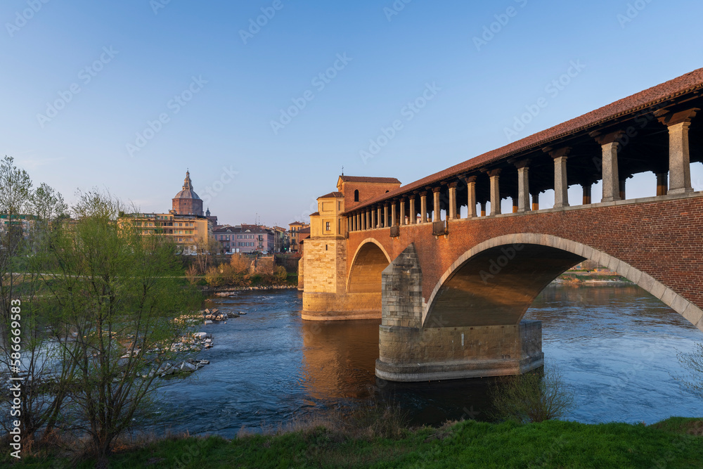 Skyline of Pavia , Ponte Coperto(covered bridge) is a bridge over the Ticino river in Pavia at sunny day, Pavia Cathedral background, Italy