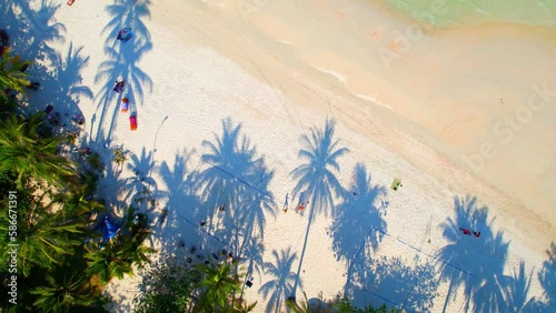 From an aerial perspective drone, you can see the long stretches of white sand that line the coast, with crowds of people gathered on the beach. (Haad Rin, Koh Phangan, Thailand). tropical concept
 photo