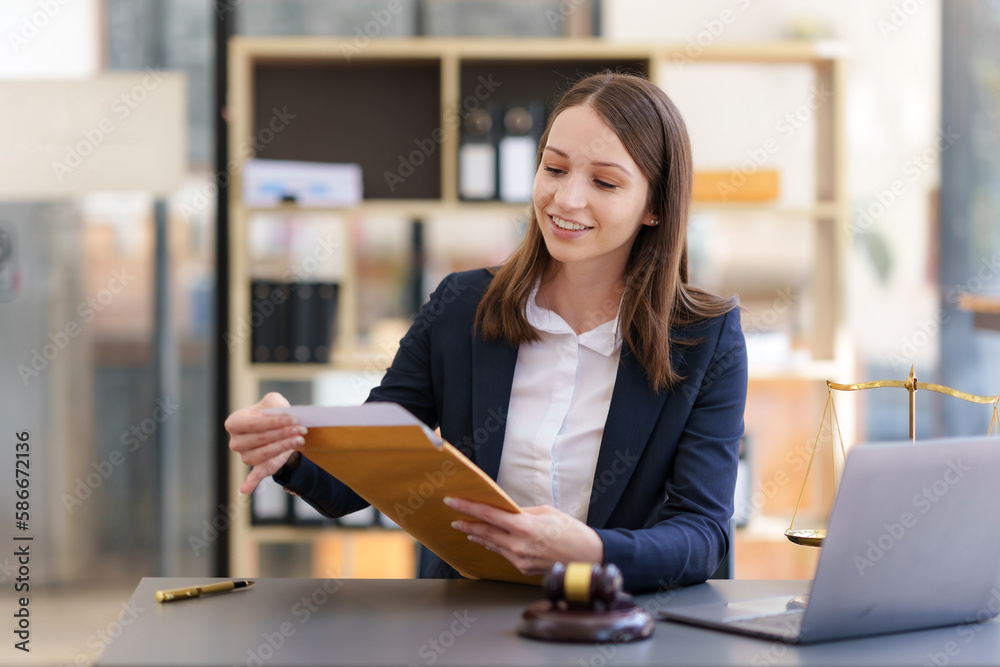 female lawyer at workplace with document and laptop in office female lawyer at workplace with document and laptop in office