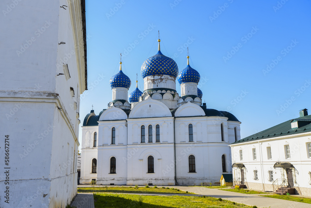 closed territory of the Epiphany Convent, beautiful white building with blue domes, sunny summer day