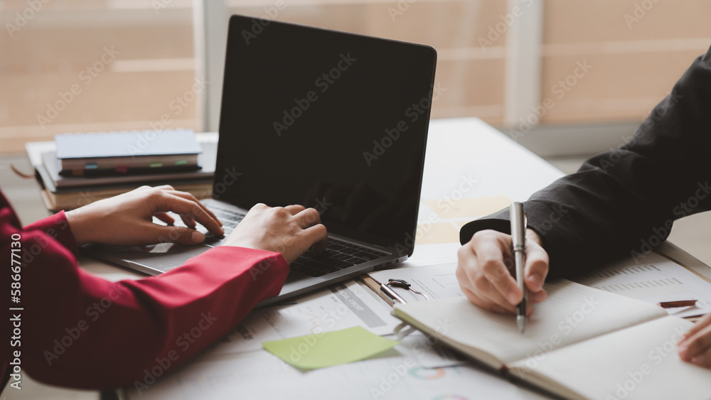 Fototapeta premium Two businessmen are brainstorming together and reviewing the company financial documents that the finance department has summarized, they are business partners. Business administration concept.