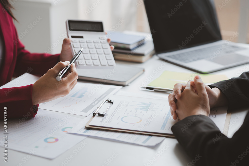 Two businessmen are brainstorming together and reviewing the company financial documents that the finance department has summarized, they are business partners. Business administration concept.