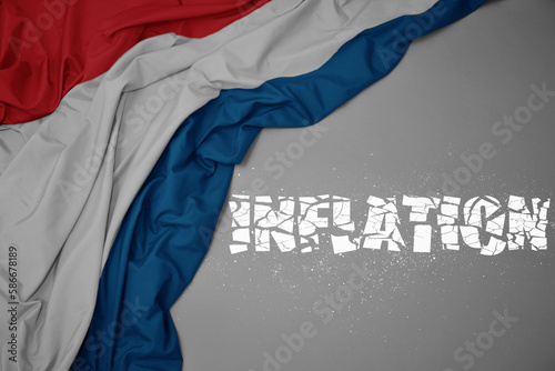 waving colorful national flag of luxembourg on a gray background with broken text inflation. 3d illustration