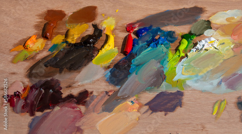 Vivid oil paint colors on paint palette taken out of the paint tubes before painting. 