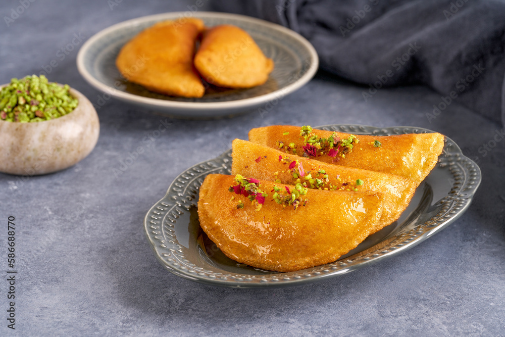 Arabian pancake Qatayef with cheese and pistachio . Traditional ramadan sweets . Arabian pancake Qatayef with cheese and pistachio . Traditional ramadan sweets .