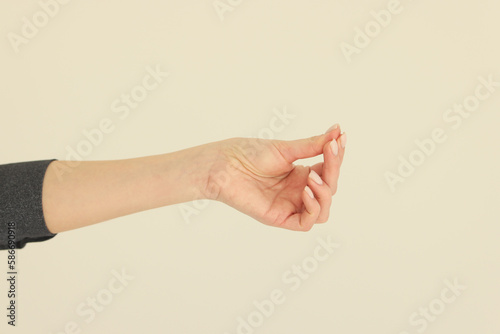 Hand of woman putting fingers together shows asking money