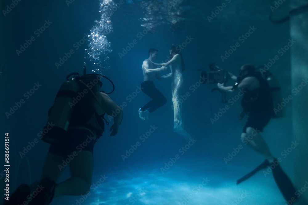 filming a movie underwater underwater cameraman and actors filming a movie underwater underwater cameraman and actors